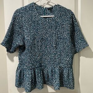 Women’s blouse. Ditzy print. Aqua. Peplum hem. Smoking across bodice and arms.